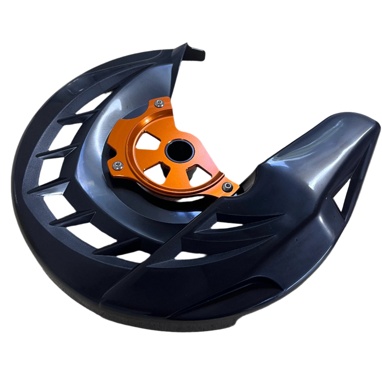 Angled view of KTM front brake disc protector showing anodized orange hub and black shield