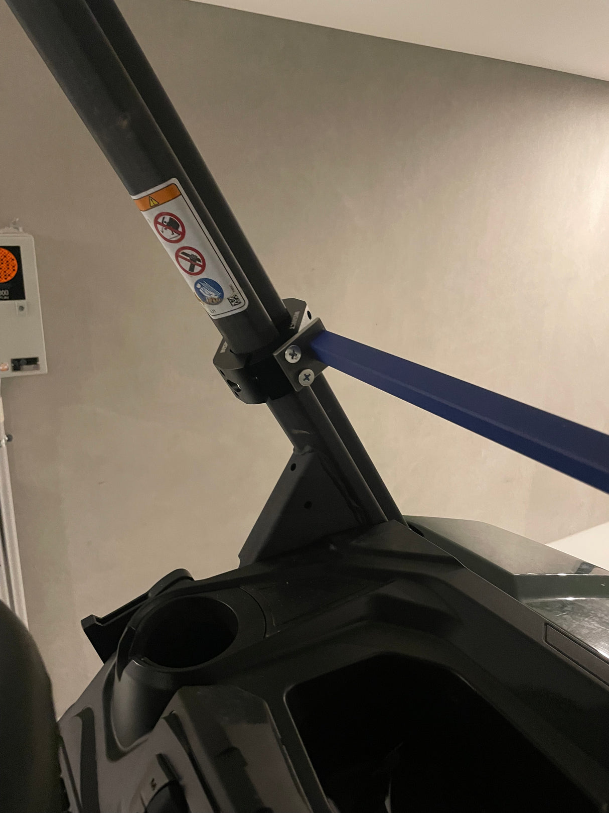 Close-up of a roll frame clamp on a Can-Am Defender, supporting a shooting platform for enhanced precision and comfort in hunting applications.