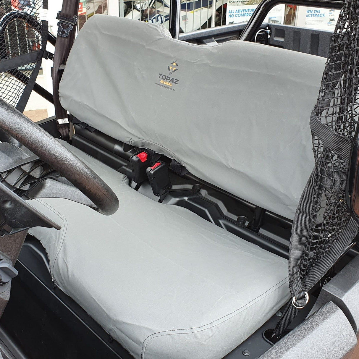 Charcoal canvas seat and backrest cover fitted on Honda Pioneer 700‑2 & 700-4, showing snug fit and heavy-duty material