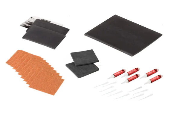 GlueTread SxS Sidewall Repair Kit contents laid out including patches, adhesive bottles, applicators and sandpaper for tyre repair