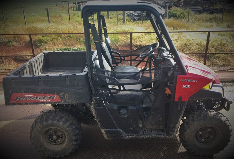 Polaris Ranger 570HD two-seater UTV with handbrake between seats, side view of 2016+ model showing cab layout and utility tray