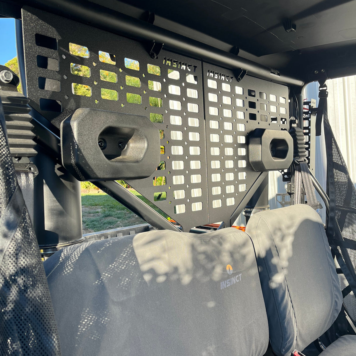 Rear view of CFMoto UForce 600 showing rifle mount MOLLE panel installed behind headrests