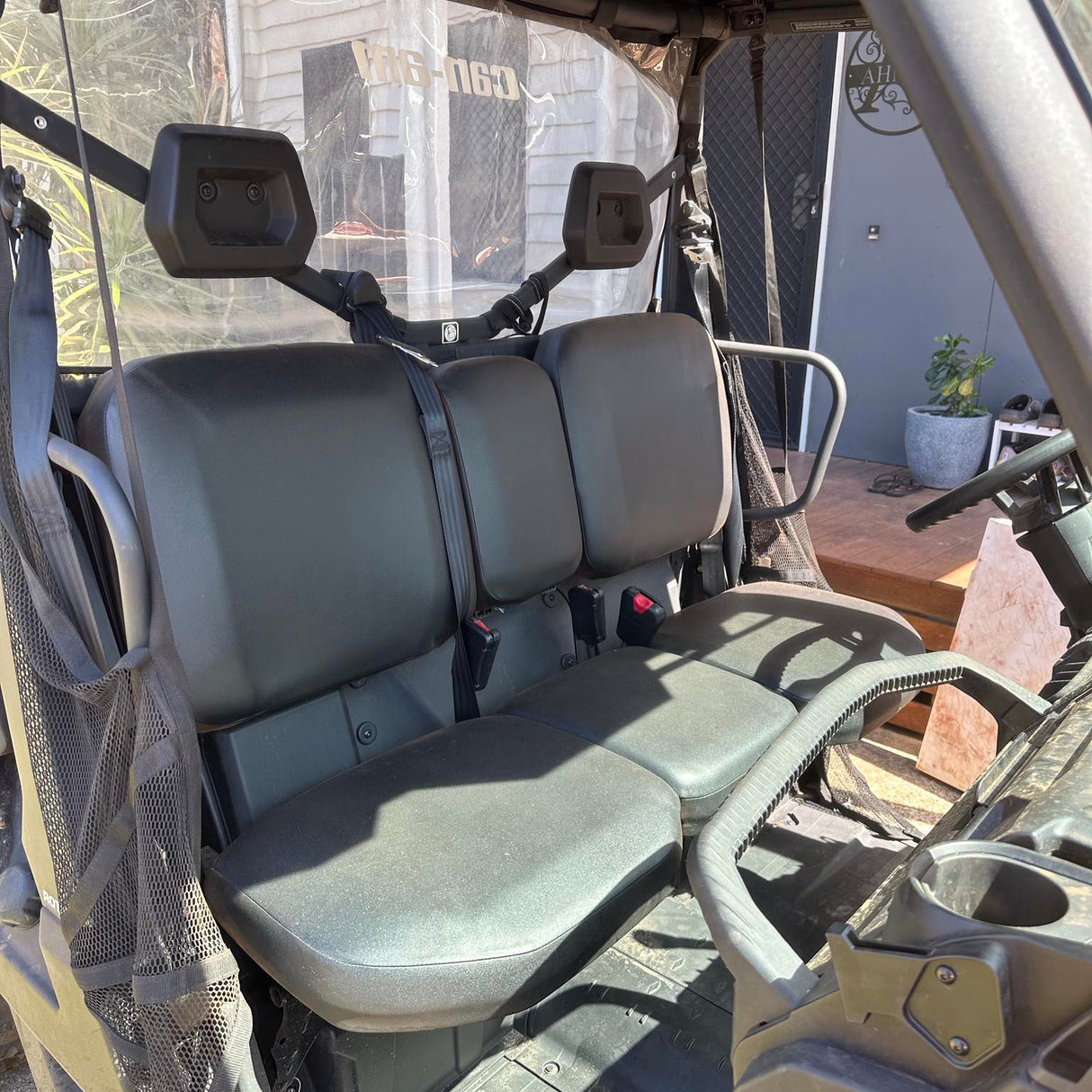 Close-up of water-resistant canvas material on Can-Am Defender seat cover, highlighting durability and premium stitching.