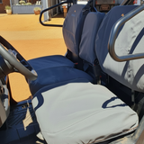 Close-up of a CFMoto U10 Pro with seat covers on a farm setting.