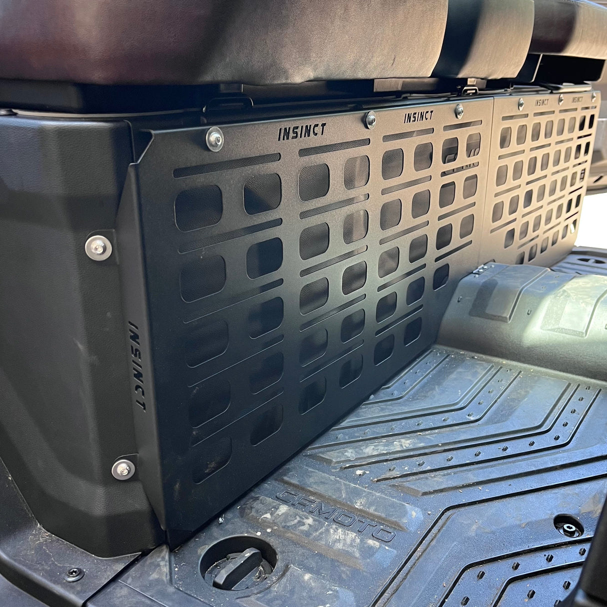 Close-up view of the installed MOLLE panel on a CFMOTO U10 Highland showing powder-coated finish and mounting points.