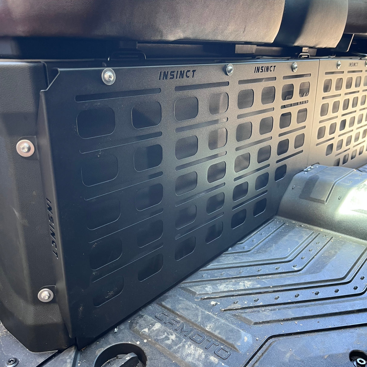 Installed MOLLE panel positioned behind the driver footwell in a CFMOTO U10, highlighting smart use of unused space.