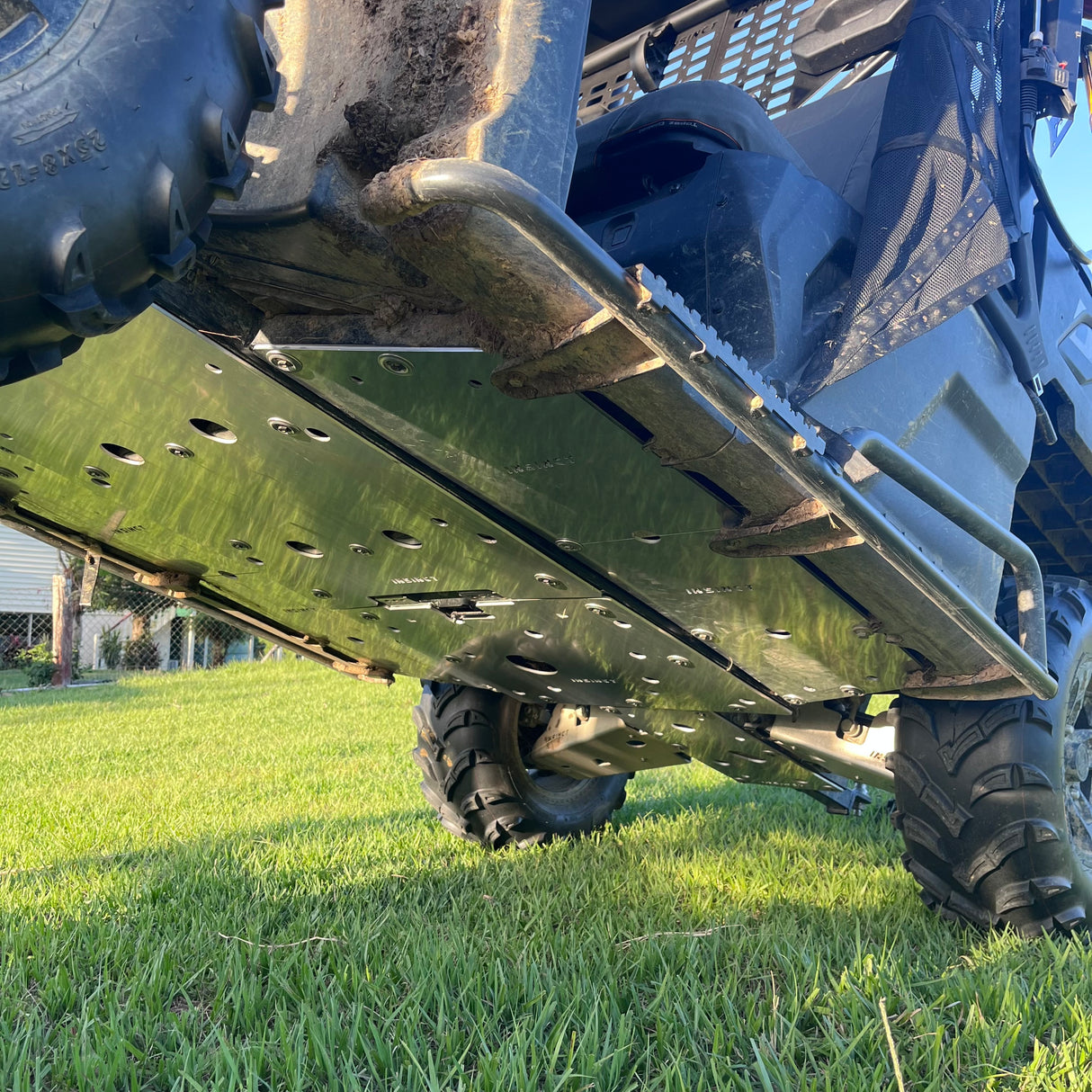 Close view of the InSinct 5mm aluminium underbody skid plate installed on a CFMoto UForce 600 while mounted on the vehicle.