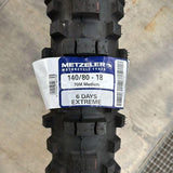 Metzeler MCE 6 Days Extreme Medium tyre tread with three red compound stripes