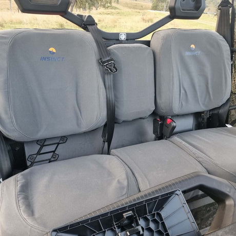 Cabvas seat covers installed on the front seats of a can am UTV, featuring the insulated logo and embroidered brand name INSINCT.